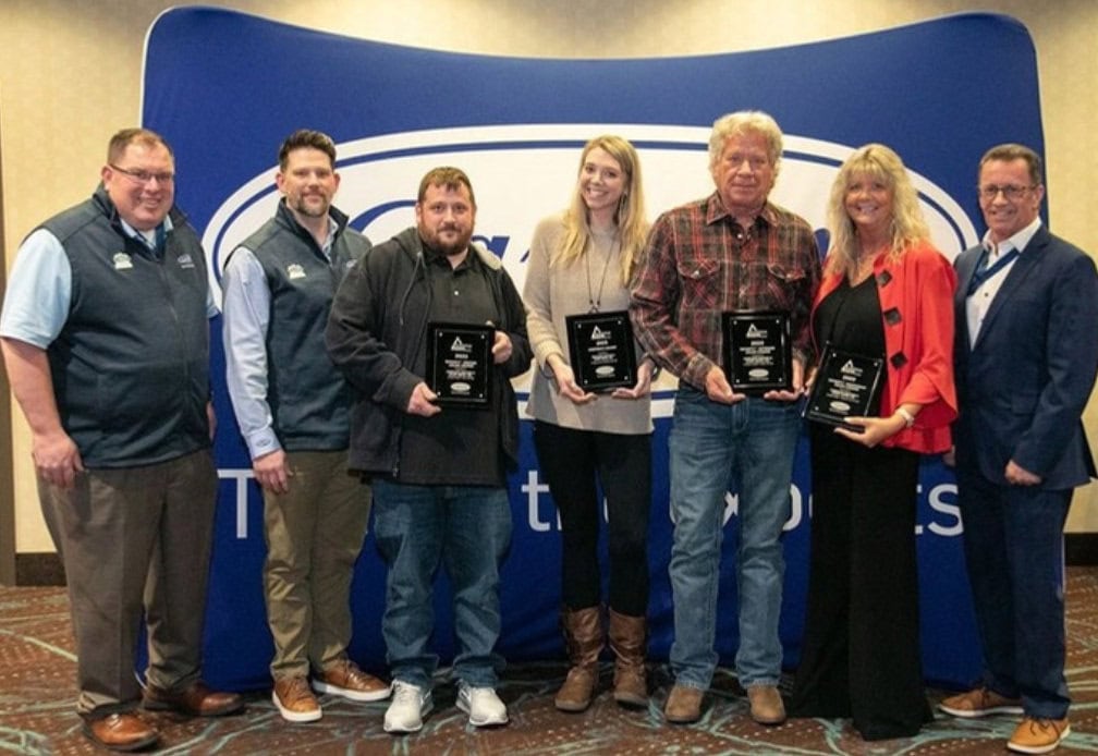 Complete Heating & Sheet Metal owner and employees holding Carrier Awards.